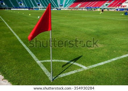 A Red flag at one corner of football stadium and soccer corner of a soccer field