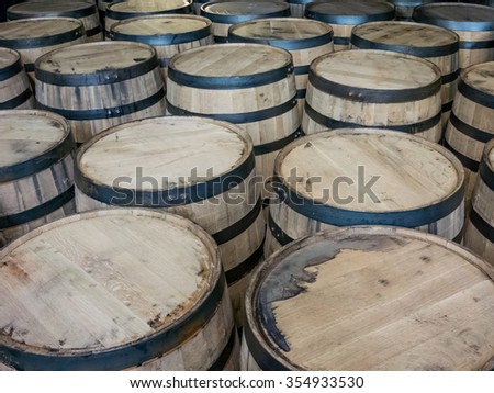 Oak barrels store bourbon whiskey for aging Royalty-Free Stock Photo #354933530