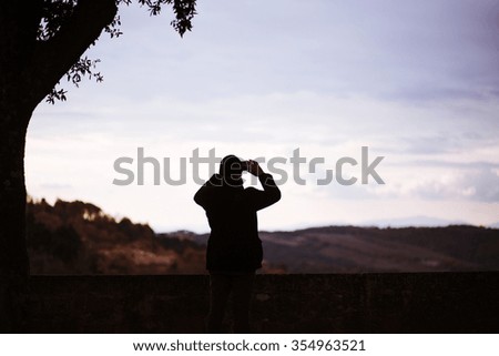 photo of man taking picture of landscape.