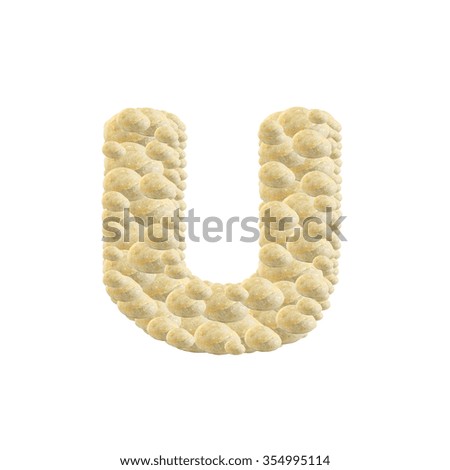 Closeup pile of brown stone in U english alphabet isolated on white background