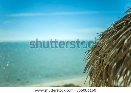 Beach Umbrella made of palm leafs on the background of an exotic beach in Cayo Largo