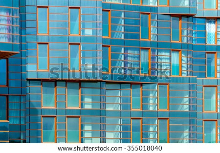 A modern building mirror facade in blue tone