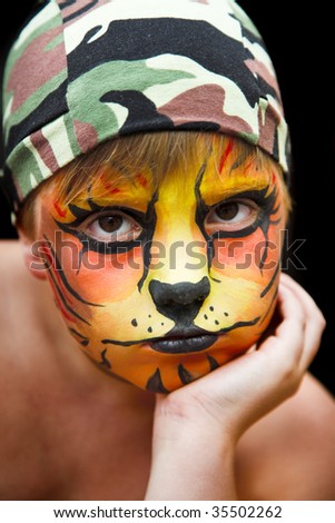 young happy boy in the tiger make-up