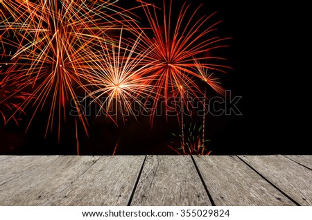 Look out from the wood table, firework on background.