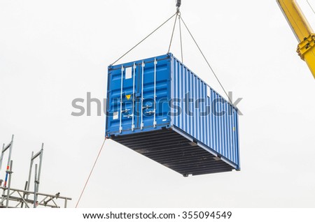 Blue building containers, cargo containers, residential containers at a loading crane. Royalty-Free Stock Photo #355094549