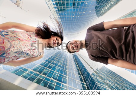 man and woman looking at the camera on top of the background of the Moscow City, close-up portrait Royalty-Free Stock Photo #355103594