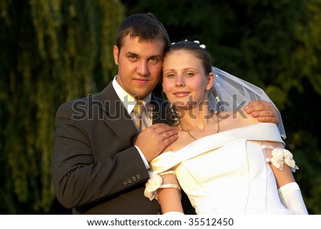 Happy wedding couple portrait in the summer park