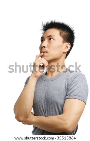 Portrait of young Asian man thinking against white background
