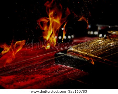 double exposure of  red electric guitar and fire flame  isolated on black background in dark