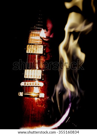 double exposure of  red electric guitar and fire flame  isolated on black background in dark