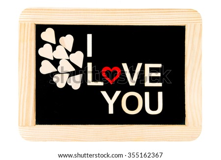 Words I LOVE YOU created of wood letters over vintage chalkboard, wood letters originated of wooden hearts, letter O replaced by red wooden heart shape, isolated on white, love conceptual image