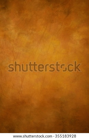Traditional painted canvas or muslin fabric cloth studio backdrop or background, suitable for use with portraits, products and concepts. Shades of ecru / yellow / brown /orange. Royalty-Free Stock Photo #355183928