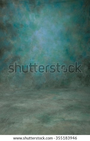 Traditional painted canvas or muslin fabric cloth studio backdrop or background, suitable for use with portraits, products and concepts. Shades of blue and green Royalty-Free Stock Photo #355183946