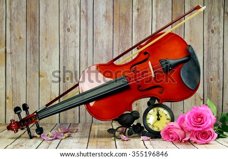 A violin and a watch still life, selective focus.