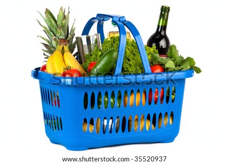 A blue plastic shopping basket on a white background filled with groceries. Royalty-Free Stock Photo #35520937