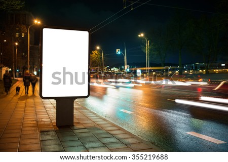 Blank advertising billboard in the city at night. Royalty-Free Stock Photo #355219688