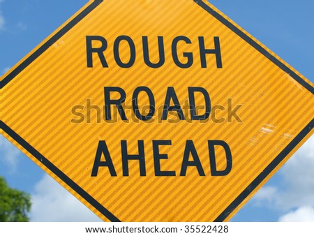 Warning sign signifying a rough road ahead.