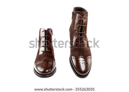 Elegant leather boots shot in studio, isolated on white.