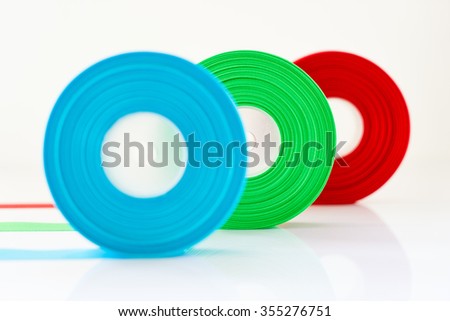 Red Green Blue ribbon Roll isolated on white background , Select focus on green