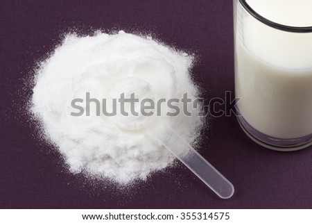 Glutamine and creatine monohydrate on a purple tablecloth. Royalty-Free Stock Photo #355314575