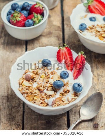 granola cereal with nuts, yoghurt and berries