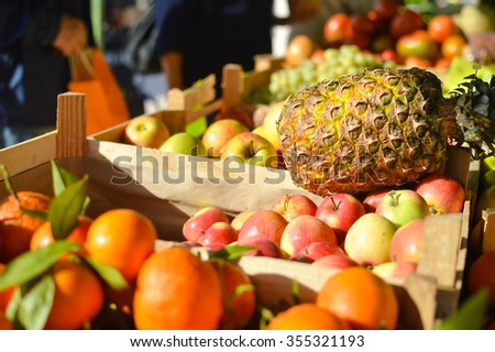 Picture of fresh fruits and vegetables at market in boxes on colorful background