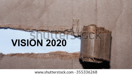 Torn paper box with word vision 2020 in low light