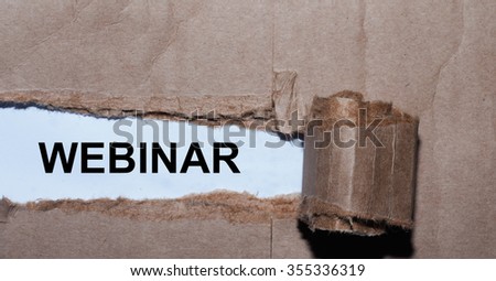 Torn paper box with word webinar in low light