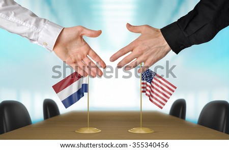 Netherlands and United States diplomats shaking hands to agree deal