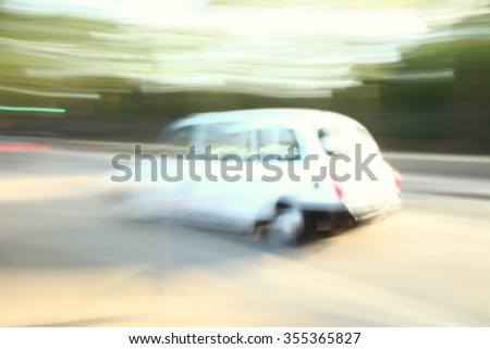 The blurry focus scene of car moving on road represent the vehicle and transportation concept related idea.