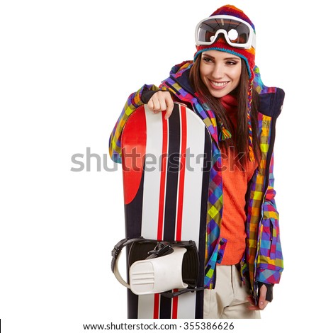 model wearing winter suit holding a snowboard in studio