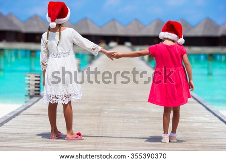 Little adorable girls during Christmas beach vacation