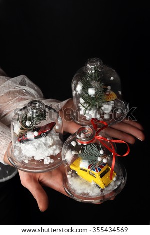 Christmas and New Year concept. Hands holding snow globes with car and tree. Hand drawn new year clipart on hand by ink, watercolor & felt-tip pen.