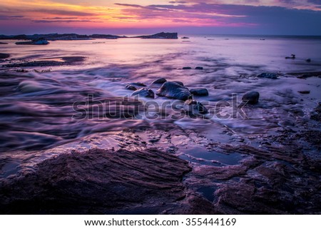 Springtime On The Shores Of Lake Superior. The sunsets on the shores of Lake Superior while icebergs float on the horizon. Pictured Rocks National Lakeshore. Munising, Michigan.