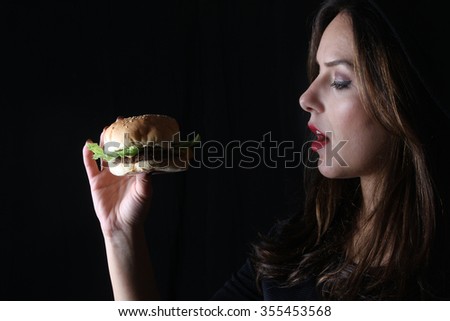 burger American junk fast food beautiful brunette girl with red lipstick on beautiful lips and beef burger with grilled bacon  facial expressions 