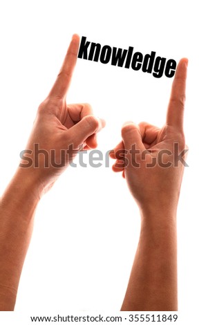 Color vertical shot of a of a hand squeezing the word "knowledge".