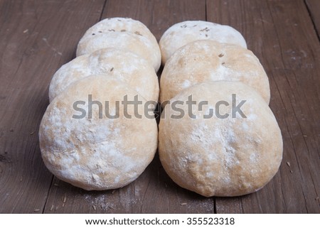 Small buns on a dark wooden background. Selective focus.