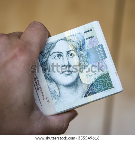 pack of money - big pile of banknotes in hand, czech crown