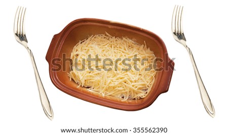 Meat dish the covered grated cheese in ceramic ware and  forks on a white background