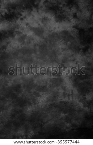 Traditional painted canvas or muslin fabric cloth studio backdrop or background, suitable for use with portraits, products and concepts. Black and gray mottled brush strokes. Royalty-Free Stock Photo #355577444