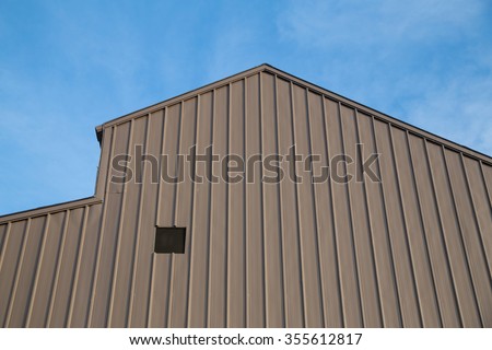 Brown metal sheet for industrial building and construction on blue sky background.