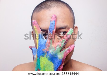 people with hands full of paint colors