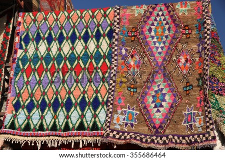 Typical hand woven Berber rugs for sale in the souks of Marrakesh, Morocco. Royalty-Free Stock Photo #355686464