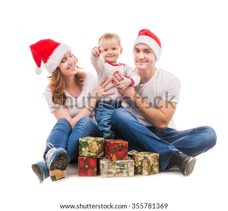 young couple with little boy and presents on the floor isolated on white background