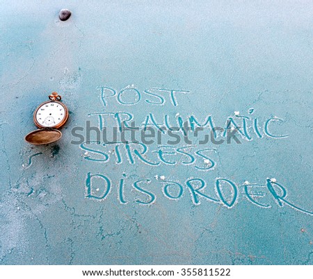 Text post traumatic stress disorder words  and vintage clock ona blue metal frost plate