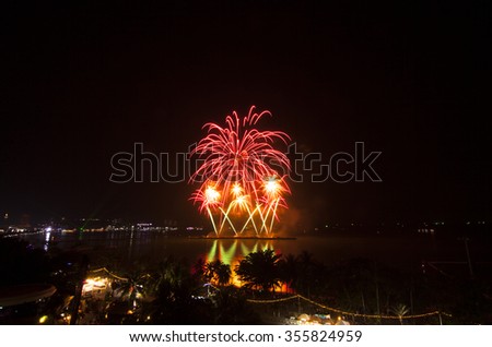 Multicolor fireworks night scene, blurred photo pattaya cityscape sea beach view, thailand