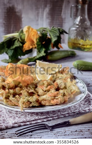 Flower Pancakes (Fritters). Homemade Zucchini Fritters with Flowers on a plate, accompanied by zucchini and zucchini flowers. Italian food