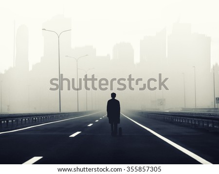 little man on the big road to the big city ,metaphorical background ,lonely and small man  on big highway to the city,looking for jobb,work seeking,