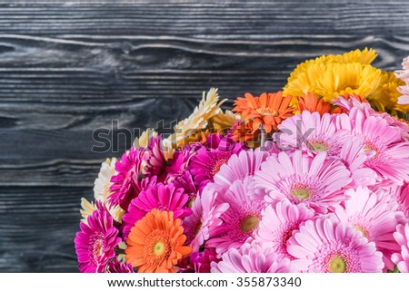 Holiday rustic background with flowers, floral border, selective focus