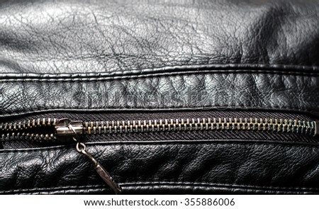Close up of zip on black leather material,horizontal photo